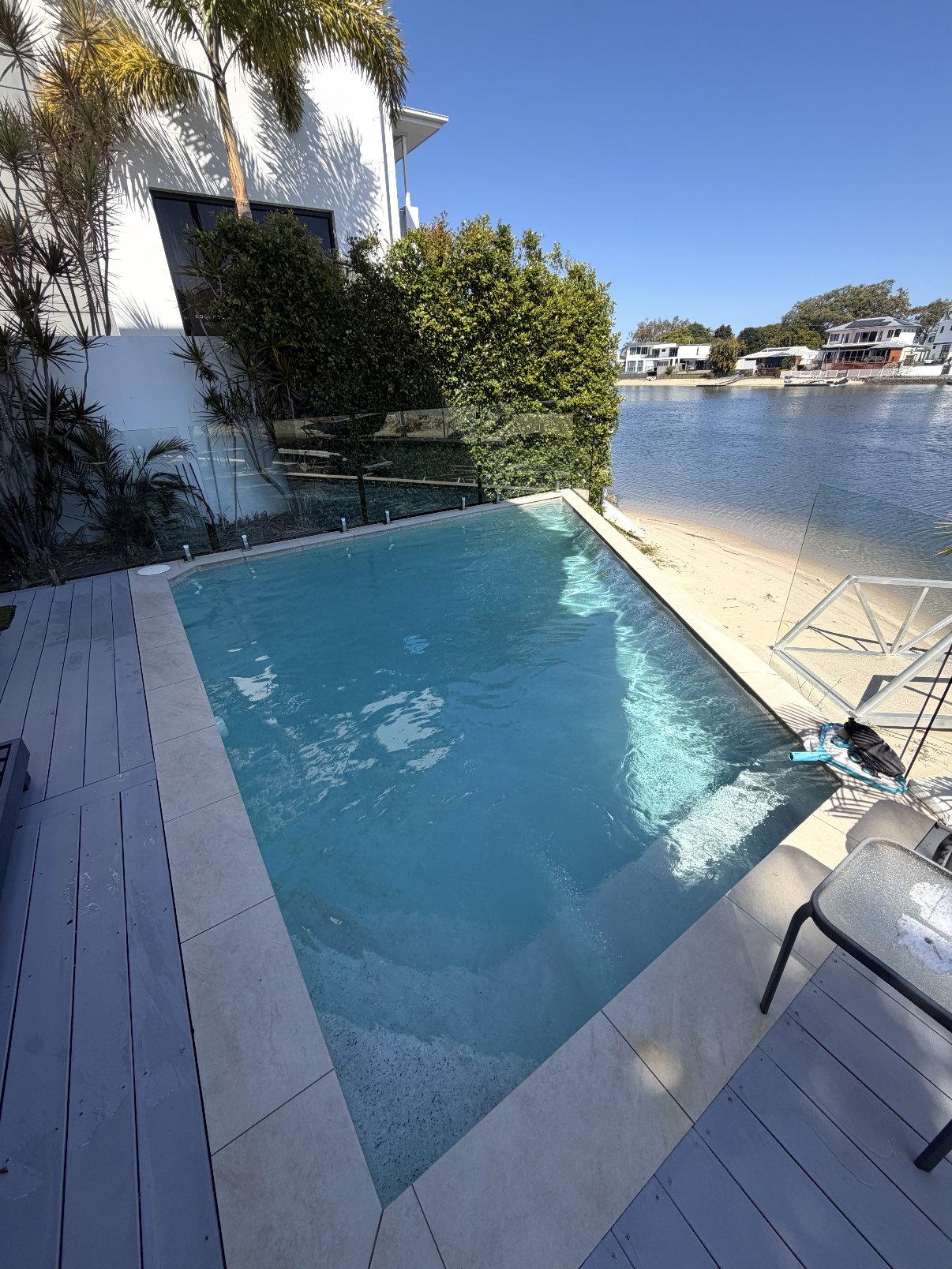 Sparkling clean waterfront pool serviced by the poolboi
